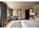 Spacious main bedroom with hardwood floors, elegant curtains, and views of the front yard at 3309 E 7Th Ave Pkwy, Denver, CO 80206