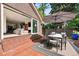 Stylish outdoor dining area with seating for six, a large umbrella, and seamless access to the indoor living space at 3309 E 7Th Ave Pkwy, Denver, CO 80206