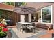 Cozy outdoor dining space with seating for six, a large umbrella, and a seamless transition to the indoor living area at 3309 E 7Th Ave Pkwy, Denver, CO 80206
