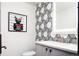 Powder room featuring patterned tile accent wall, vanity with marble countertop and modern art at 3309 E 7Th Ave Pkwy, Denver, CO 80206