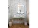 Stylish powder room with a unique mirror, decorative wall tiles, and a glass sink at 3309 E 7Th Ave Pkwy, Denver, CO 80206