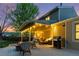 Inviting backyard with a deck, string lights, a grill, and comfortable seating, perfect for outdoor entertaining at 504 E Otero Ct, Littleton, CO 80122