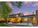 Inviting backyard with a deck, string lights, a grill, and comfortable seating, perfect for outdoor entertaining at 504 E Otero Ct, Littleton, CO 80122