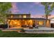 Backyard at twilight featuring the back deck with outdoor seating, fire pit, and grill at 504 E Otero Ct, Littleton, CO 80122