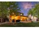 Inviting backyard with a covered patio, string lights, a grill, and comfortable seating, perfect for outdoor entertaining at 504 E Otero Ct, Littleton, CO 80122