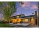 Inviting backyard with a deck, string lights, a grill, and comfortable seating, perfect for outdoor entertaining at 504 E Otero Ct, Littleton, CO 80122