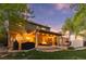 Inviting backyard with a covered patio, string lights, a grill, and comfortable seating, perfect for outdoor entertaining at 504 E Otero Ct, Littleton, CO 80122