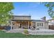 Spacious backyard with a back deck featuring outdoor furniture, a grill, and a fire pit at 504 E Otero Ct, Littleton, CO 80122
