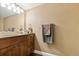Cozy bathroom featuring wood vanity, granite countertop, and warm paint color at 504 E Otero Ct, Littleton, CO 80122