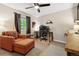 This bedroom has a large window, an orange lounge chair and an open workspace at 504 E Otero Ct, Littleton, CO 80122