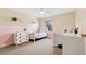 Bedroom with two beds, a dresser, a white hutch, a ceiling fan, and a large window at 504 E Otero Ct, Littleton, CO 80122