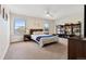 This bedroom has 2 windows, a bed, a shelf full of books and a nightstand with a desk lamp at 504 E Otero Ct, Littleton, CO 80122