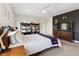 This bedroom features a built-in bookshelf, ceiling fan, dark accent wall, and a large window at 504 E Otero Ct, Littleton, CO 80122
