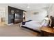 A spacious bedroom with a dark accent wall, ceiling fan and warm natural light at 504 E Otero Ct, Littleton, CO 80122