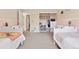 This room features two twin beds, a closet, and pink and white wainscoting along the walls at 504 E Otero Ct, Littleton, CO 80122