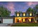 Welcoming two-story home with brick accents, a covered porch, and a lush green lawn, perfect for families at 504 E Otero Ct, Littleton, CO 80122