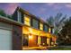Lovely home featuring a covered porch with decorative columns, brick accents, and exterior lighting at 504 E Otero Ct, Littleton, CO 80122