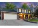 Charming two-story home with brick and siding exterior, covered porch, and well-maintained lawn at 504 E Otero Ct, Littleton, CO 80122