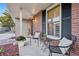 Inviting front porch featuring seating, plants, brick accents, and a cozy, welcoming atmosphere at 504 E Otero Ct, Littleton, CO 80122