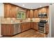 This gourmet kitchen boasts custom cabinetry, stainless steel appliances, and tiled backsplash at 504 E Otero Ct, Littleton, CO 80122