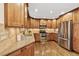Bright kitchen featuring custom cabinetry, stainless steel appliances, and gleaming hardwood floors at 504 E Otero Ct, Littleton, CO 80122