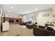 Bright living room boasts a brick fireplace, neutral tones, and a large window for natural light at 504 E Otero Ct, Littleton, CO 80122
