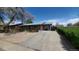 Brick home featuring a long driveway and mature trees at 7620 Hooker St, Westminster, CO 80030