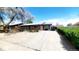 Brick home featuring a spacious driveway, front yard, and inviting curb appeal at 7620 Hooker St, Westminster, CO 80030