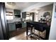 Updated kitchen with gray cabinets, stainless steel appliances, and breakfast bar at 7620 Hooker St, Westminster, CO 80030