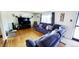 Open-concept living room with hardwood floors and comfortable blue seating at 7620 Hooker St, Westminster, CO 80030