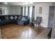 Cozy living room featuring hardwood floors, a comfortable blue sofa and plenty of natural light at 7620 Hooker St, Westminster, CO 80030