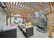 Outdoor patio area under a pergola includes a hanging chair and fun hand-shaped chair at 3285 N Monaco Pkwy, Denver, CO 80207