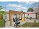 Lovely backyard showcasing a pergola-covered seating area and a red umbrella for a serene retreat at 3285 N Monaco Pkwy, Denver, CO 80207