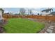 Spacious backyard offers a playground, garden beds, and ample green space for recreation and relaxation at 3285 N Monaco Pkwy, Denver, CO 80207