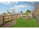 Lush backyard featuring a well-manicured lawn, pergola with patio furniture, and privacy fencing at 3285 N Monaco Pkwy, Denver, CO 80207