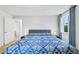 Bright bedroom features a cozy bed, shiplap wall, hardwood floors, and lots of natural light at 3285 N Monaco Pkwy, Denver, CO 80207