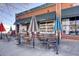 Commercial storefront with outdoor seating underneath string lights and umbrellas at 3285 N Monaco Pkwy, Denver, CO 80207