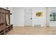 Entryway features hardwood floors, coat rack, and colorful artwork on the wall at 3285 N Monaco Pkwy, Denver, CO 80207