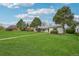 Expansive front yard with mature trees and lush lawn at 3285 N Monaco Pkwy, Denver, CO 80207