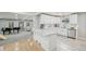 Modern kitchen with stainless appliances, white cabinets, quartz countertop, and an open concept design at 3285 N Monaco Pkwy, Denver, CO 80207