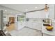 Modern kitchen with stainless appliances, white cabinets, quartz countertop, and an open concept design at 3285 N Monaco Pkwy, Denver, CO 80207
