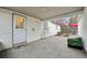Covered patio area for outdoor dining, featuring a door and view of the lovely yard at 3285 N Monaco Pkwy, Denver, CO 80207