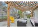 Backyard features an outdoor lounge area under a wooden pergola at 3285 N Monaco Pkwy, Denver, CO 80207