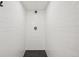 A modern shower stall featuring white subway tile walls and a black honeycomb tile floor at 3285 N Monaco Pkwy, Denver, CO 80207