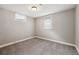 This is a carpeted basement room with white baseboard trim and bright, sunlit windows at 7833 Raritan St, Denver, CO 80221