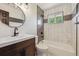 A beautifully renovated bathroom with modern vanity, a unique mirror, plus shower and tub at 7833 Raritan St, Denver, CO 80221
