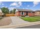 Charming single-story brick home with well-maintained lawn and inviting outdoor seating at 7833 Raritan St, Denver, CO 80221