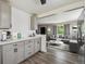 Bright kitchen open to the living room featuring ample counter space and modern cabinets at 7833 Raritan St, Denver, CO 80221