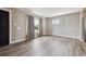 Bright living room with hardwood floors and lots of natural light from two large windows at 7833 Raritan St, Denver, CO 80221