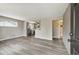 Open-concept living area featuring new floors, stainless steel appliances, and access to the bathroom at 7833 Raritan St, Denver, CO 80221